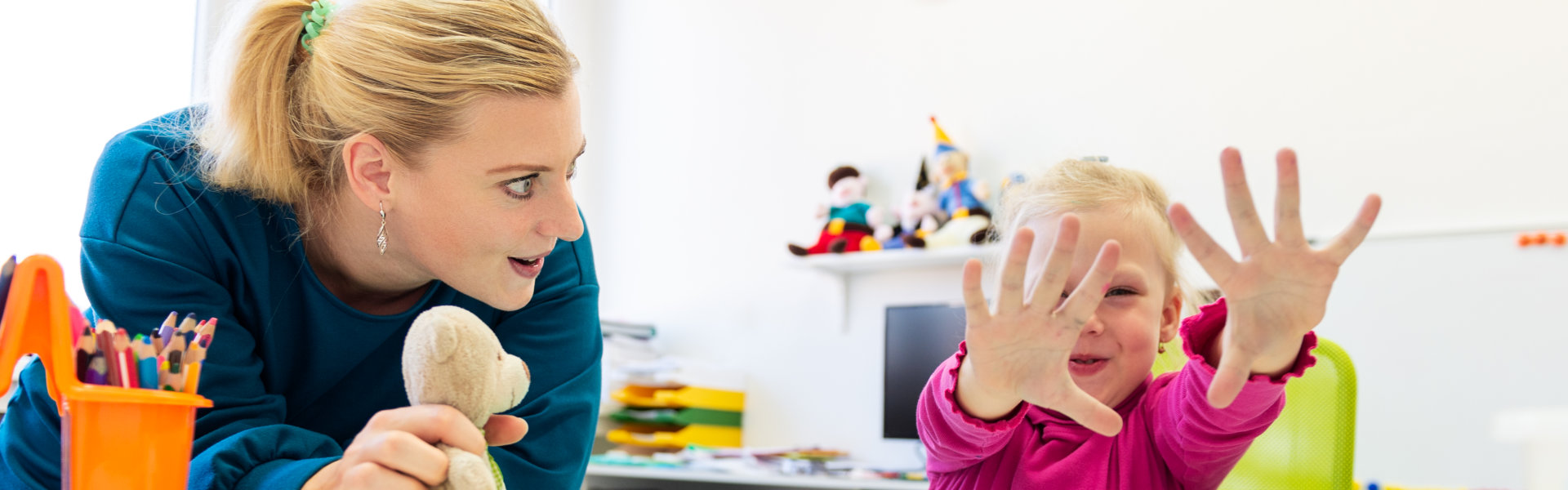 young girl doing sensory exercise with her therapist